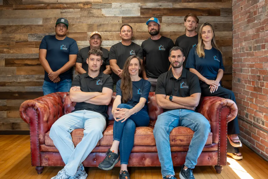 Team photo of Verified Builders designers, estimators, contractors, and office staff in Denver.