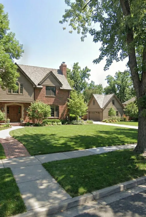 A sprawling traditional brick estate at Sedgwick Dr, Englewood, CO 80113, featuring a large, matching detached carriage house ADU. This strategic upgrade increases square footage and significantly boosts long-term property market value in the Denver area landscape.