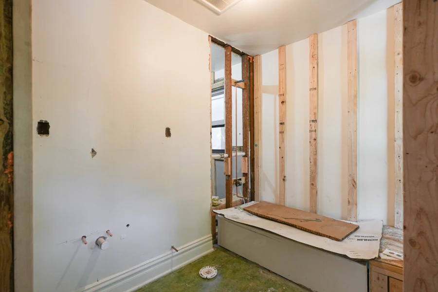 The structural wood framing phase for a new master bedroom suite and bathroom addition in a historic Denver home, showing the re-engineered classic floor plan.