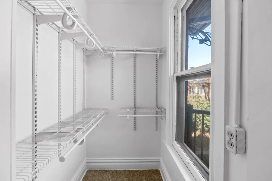 Finished walk-in closet in a historic Denver home remodel, featuring a custom wire shelving system and optimized floor plan layout for maximum efficiency.