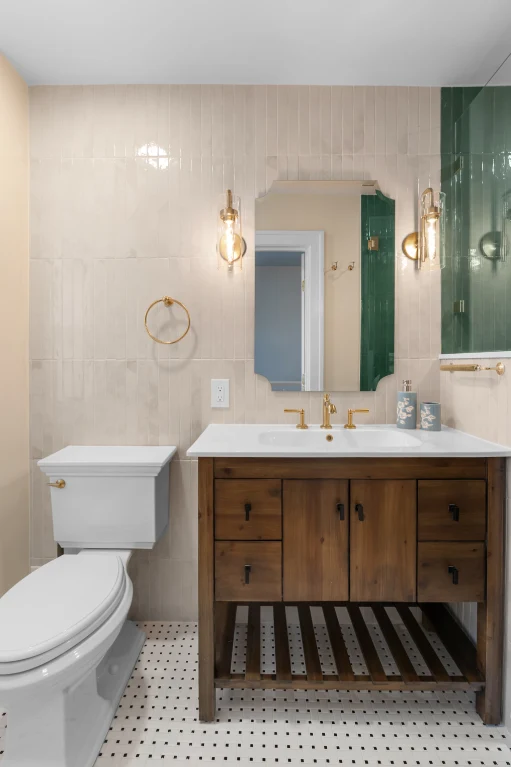 Delta brass shower system with ceiling rainhead, wall-mounted head, and handheld in a green-tiled walk-in shower.