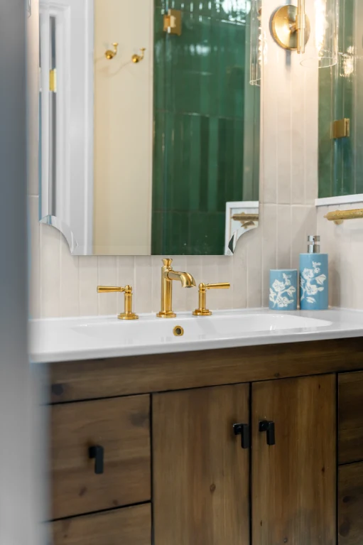 Walk-in shower walls in 2x10 Forest green porcelain tile stacked vertically, with brass Delta shower fixtures.