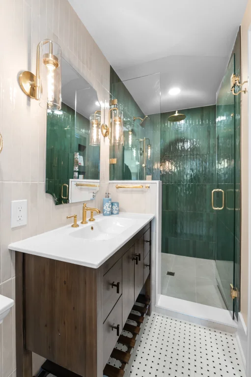 Finished West Highland Denver bathroom with wood vanity, brass faucet, and walk-in shower with green Forest porcelain tile.