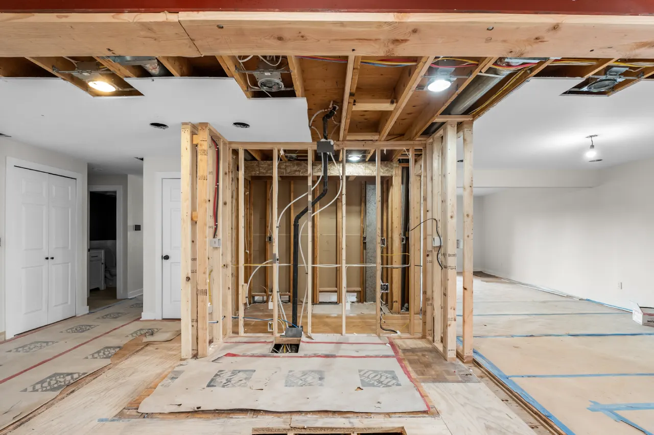 During: steel beam overhead and framing for the built-in refrigerator with the walk-in pantry behind it