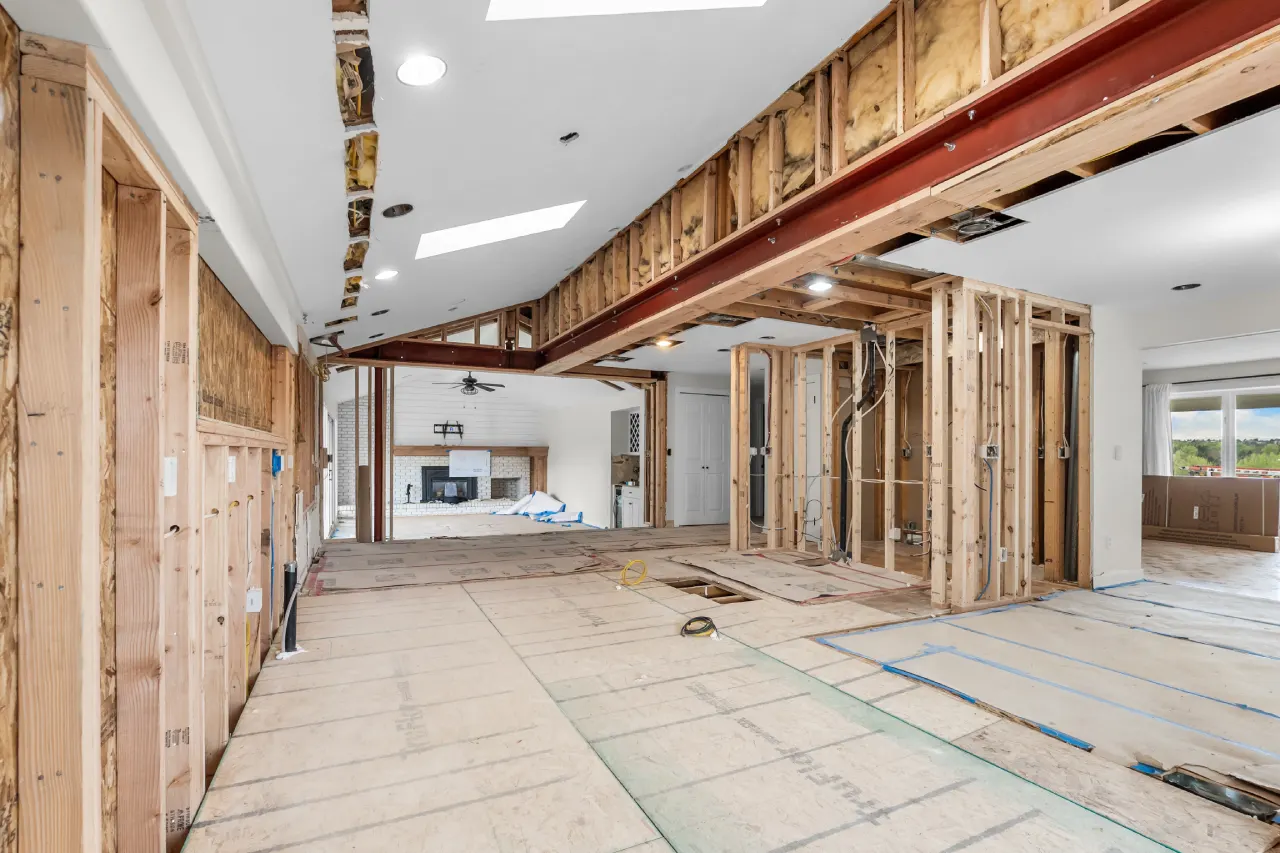 During the Centennial kitchen remodel: two steel beams in place where the load-bearing walls came out, living room fireplace beyond